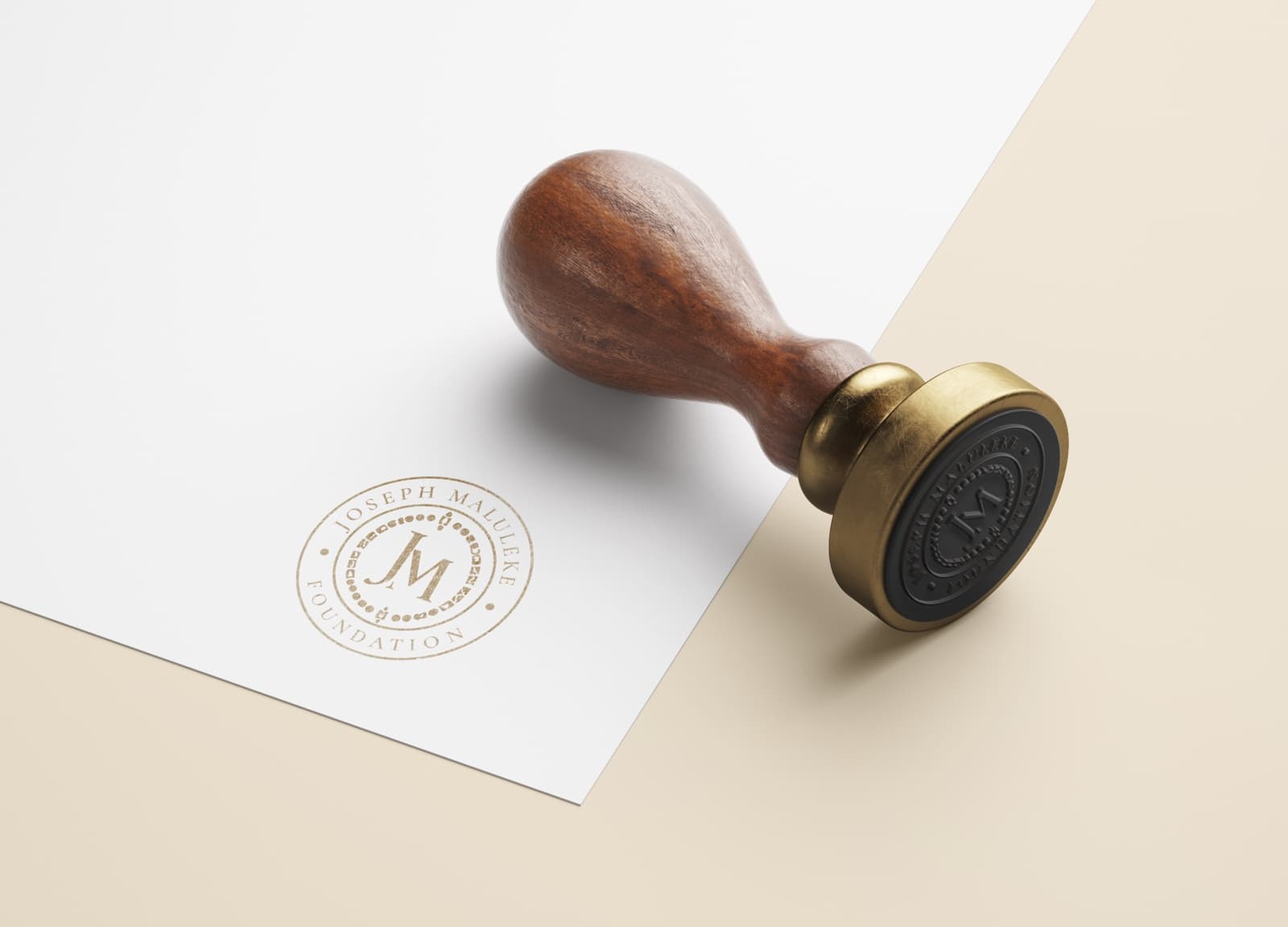 Brass stamp beside its gold-ink impression of the seal